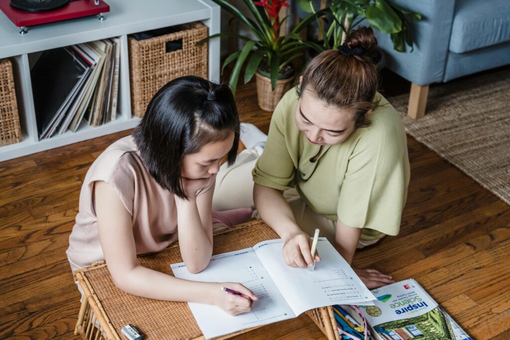 Mother helping child in a homework